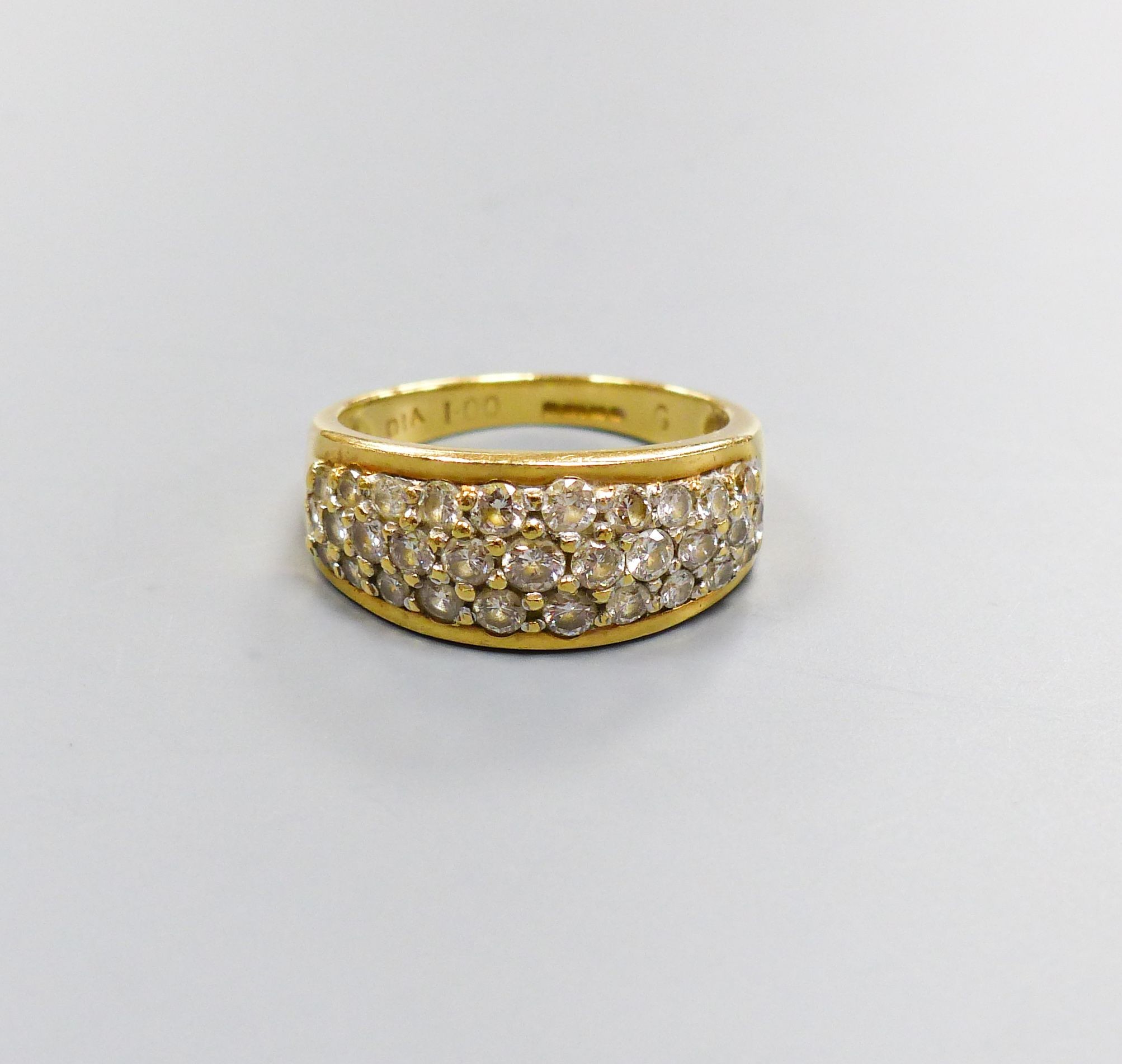 A modern 18ct gold and diamond encrusted half hoop ring, total diamond weight approx. 1.00ct, size N, gross 5.4 grams.